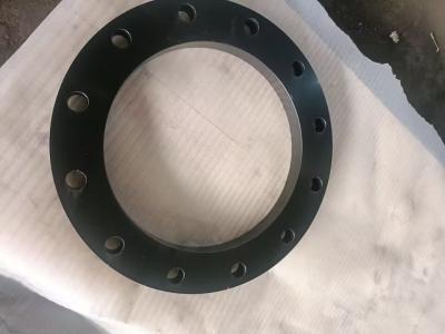 This image shows a black flat flange, featuring a circular structure with multiple evenly spaced mounting holes around its edge. It is placed on a textured light-colored backing material. As a pipeline fitting, this flange is typically used for connecting or sealing pipe sections, and its black surface (likely a protective coating) may provide corrosion resistance for industrial or plumbing applications.        法兰的安装孔有什么作用？ 法兰的材质对其性能有哪些影响？ 如何选择适合的法兰尺寸？
