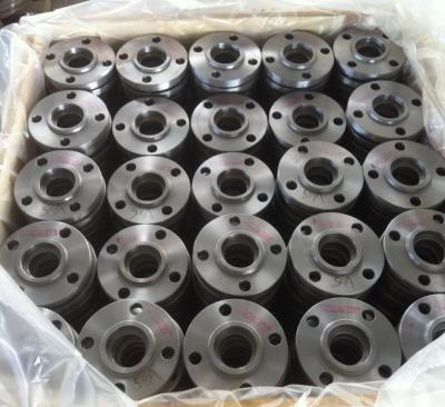 A batch of metallic flat flanges (marked with specifications like "50A") are neatly stacked in a wooden crate, wrapped with transparent plastic film. These steel flanges (for pipeline connection) feature a uniform metallic luster, with standard structures including central bores and bolt holes.